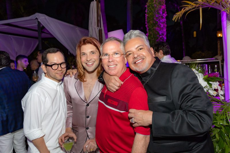 Thomas Henry posing for picture with party guests