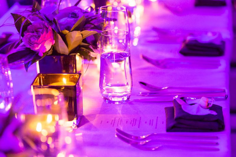 Dinner menu and table setting with fresh orchid